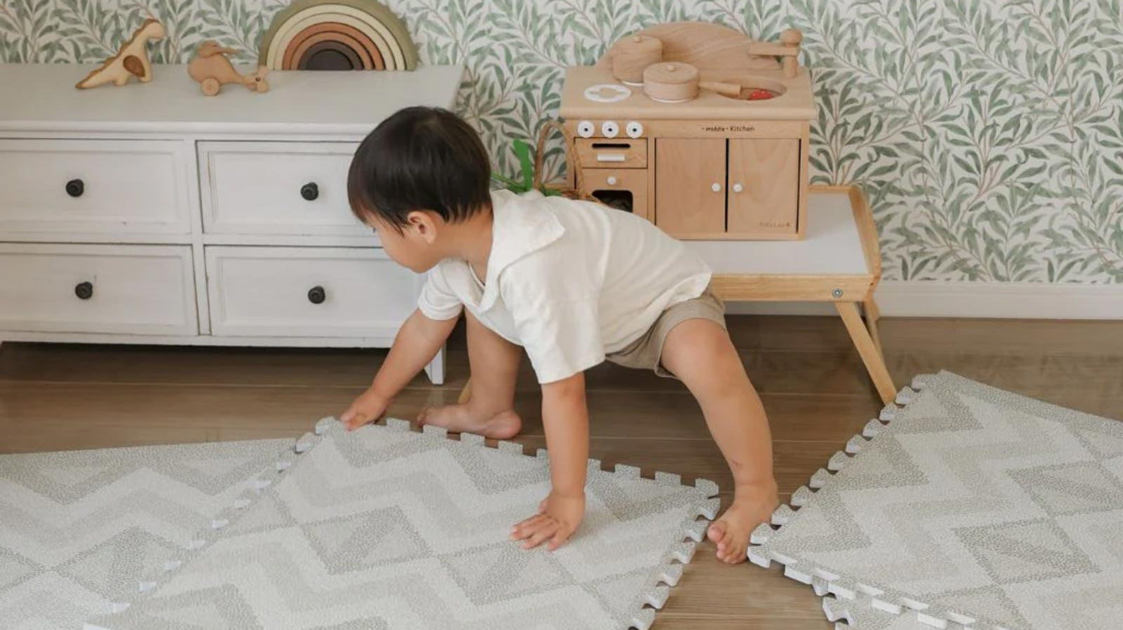 Child assembling an Eeveve EVA foam play mat independently.