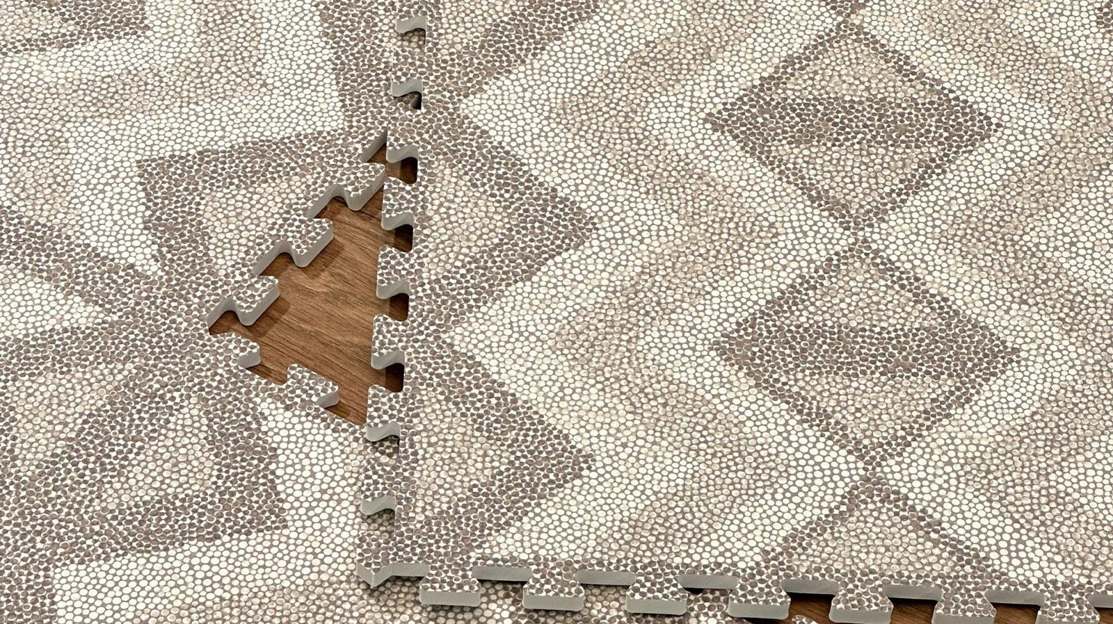 Close-up of an Eeveve Kilim Truffle play mat with tiles not yet clicked together, showing interlocking edges.