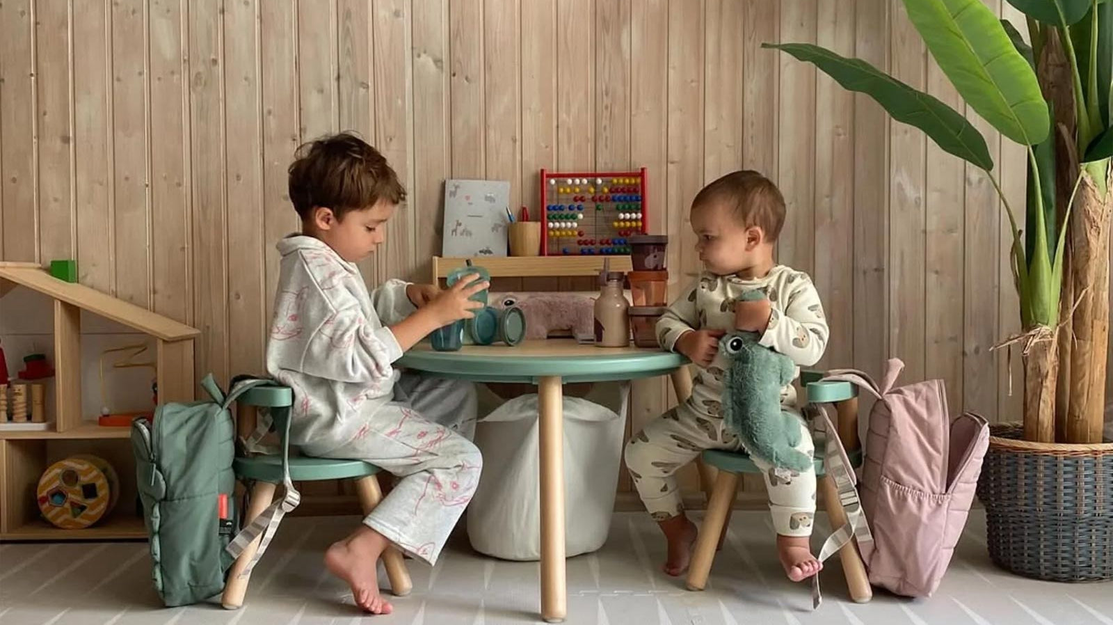 Two children enjoying playtime on an Eeveve foam play mat in a bright, cozy room.