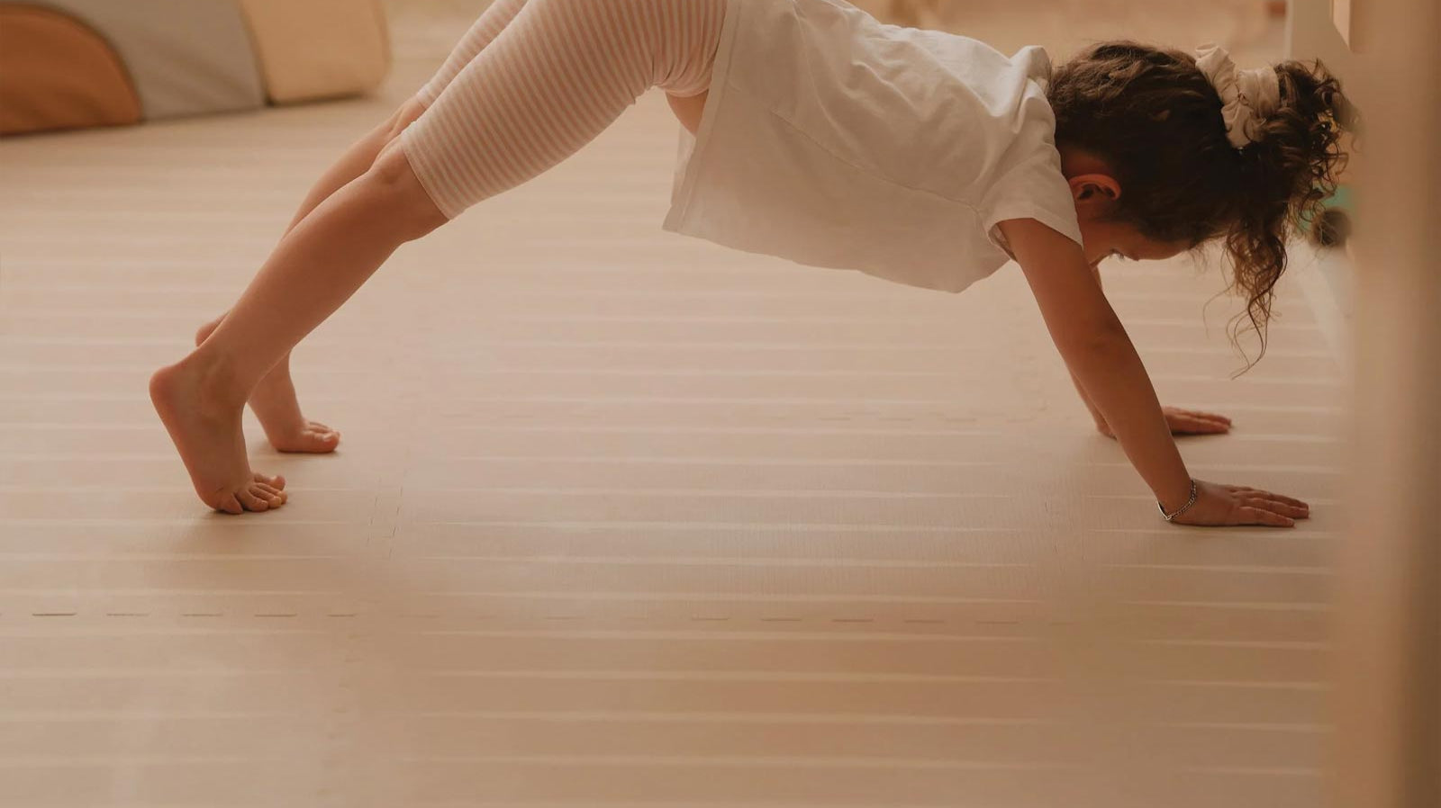 Child practicing yoga on an Eeveve Lucio Linen play mat.