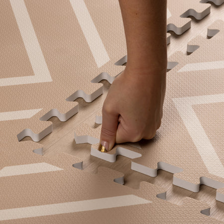 Hand assembling Modern Blocks Play Mat with easy interlocking edges. Soft, thick EVA foam ensures comfort and safety for babies and toddlers.