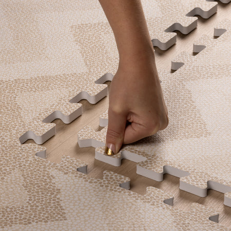 Hand assembling Kilim Sand Play Mat with easy interlocking EVA foam tiles. Durable play mat for safe baby activities.
