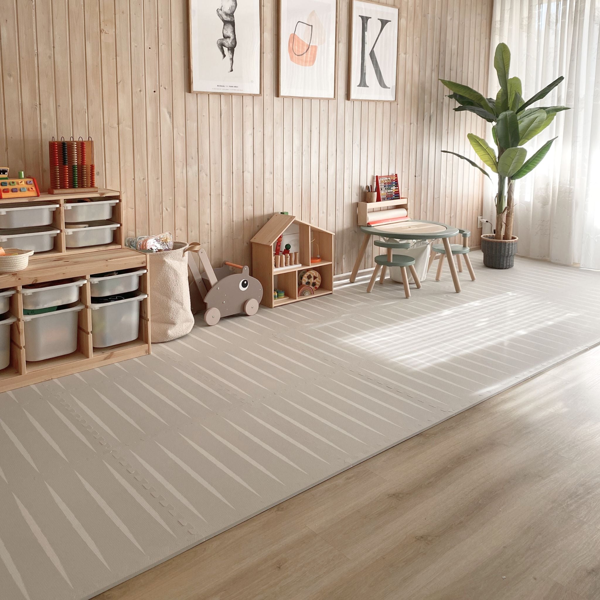 Large playroom with Lucio play mat in linen by Eeveve. Non-toxic EVA foam mat complements wooden furniture and natural light.