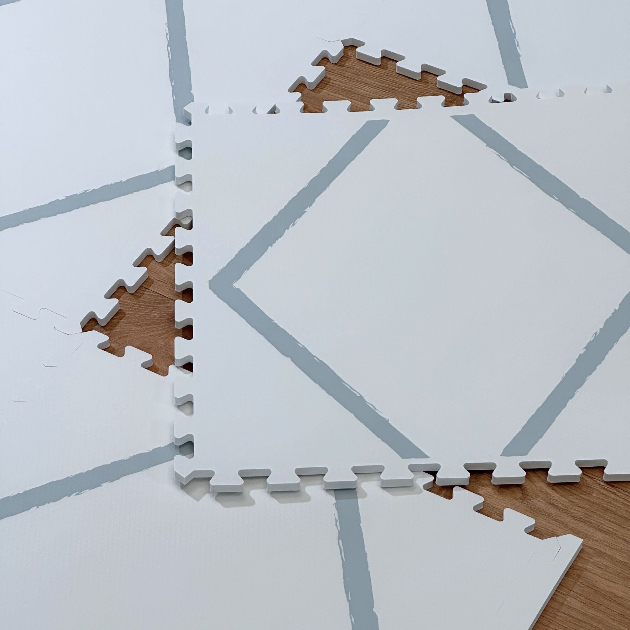 Scattered interlocking tiles of the Beni Powder Blue play mat, demonstrating its modular design and ease of storage or expansion.