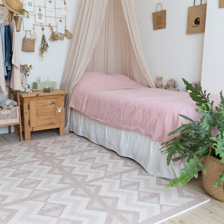 Eeveve Kilim Soft Clay play mat placed beside a child's bed. EVA foam mat with modern design for stylish nursery decor.