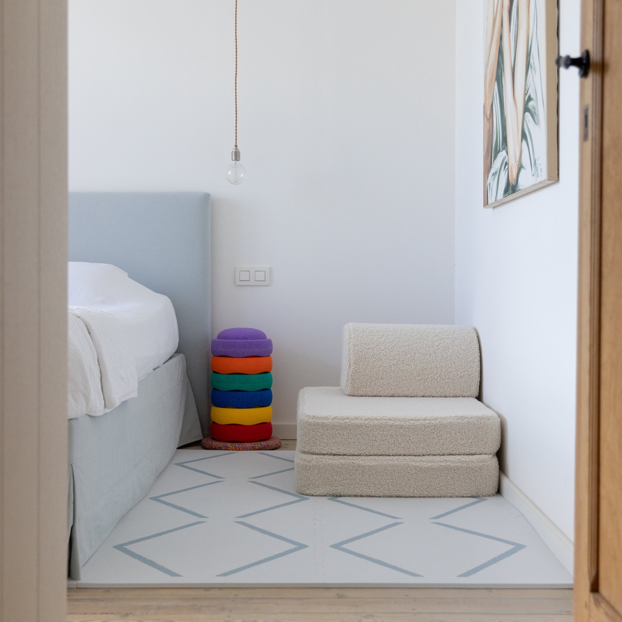 Play Mat Beni Powder Blue by Eeveve in a modern bedroom corner, offering a soft, non-toxic EVA foam surface for toddlers and babies.