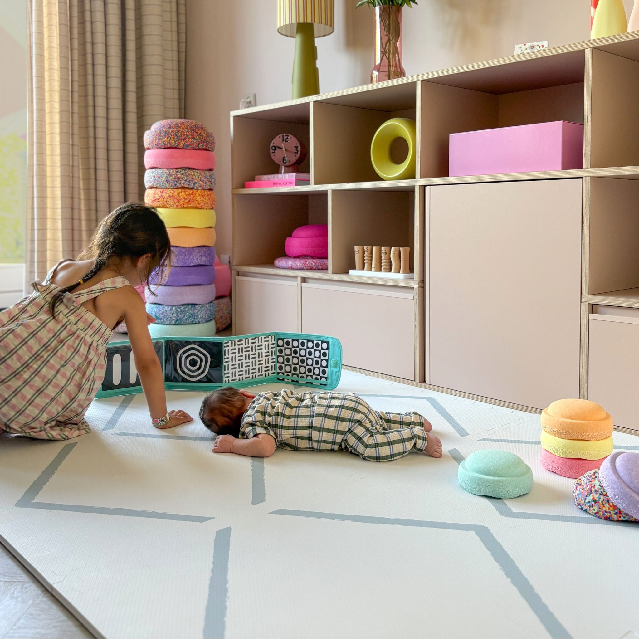 Children playing on the Beni Powder Blue play mat by Eeveve, ideal for tummy time and safe floor play in a stylish nursery setting.