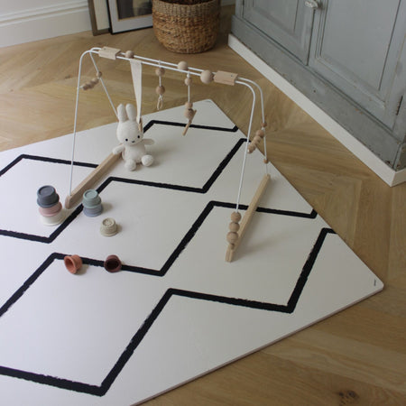 Baby gym setup on Eeveve Beni - Ecru EVA foam play mat with toys, offering a safe and stylish surface for infant play and development.