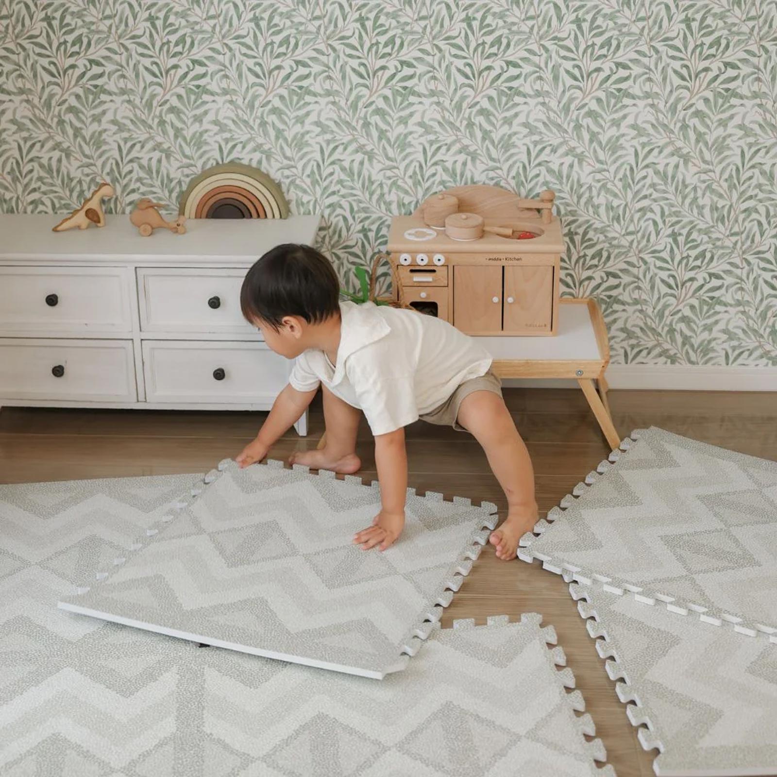 Child assembling an Eeveve EVA foam play mat independently.