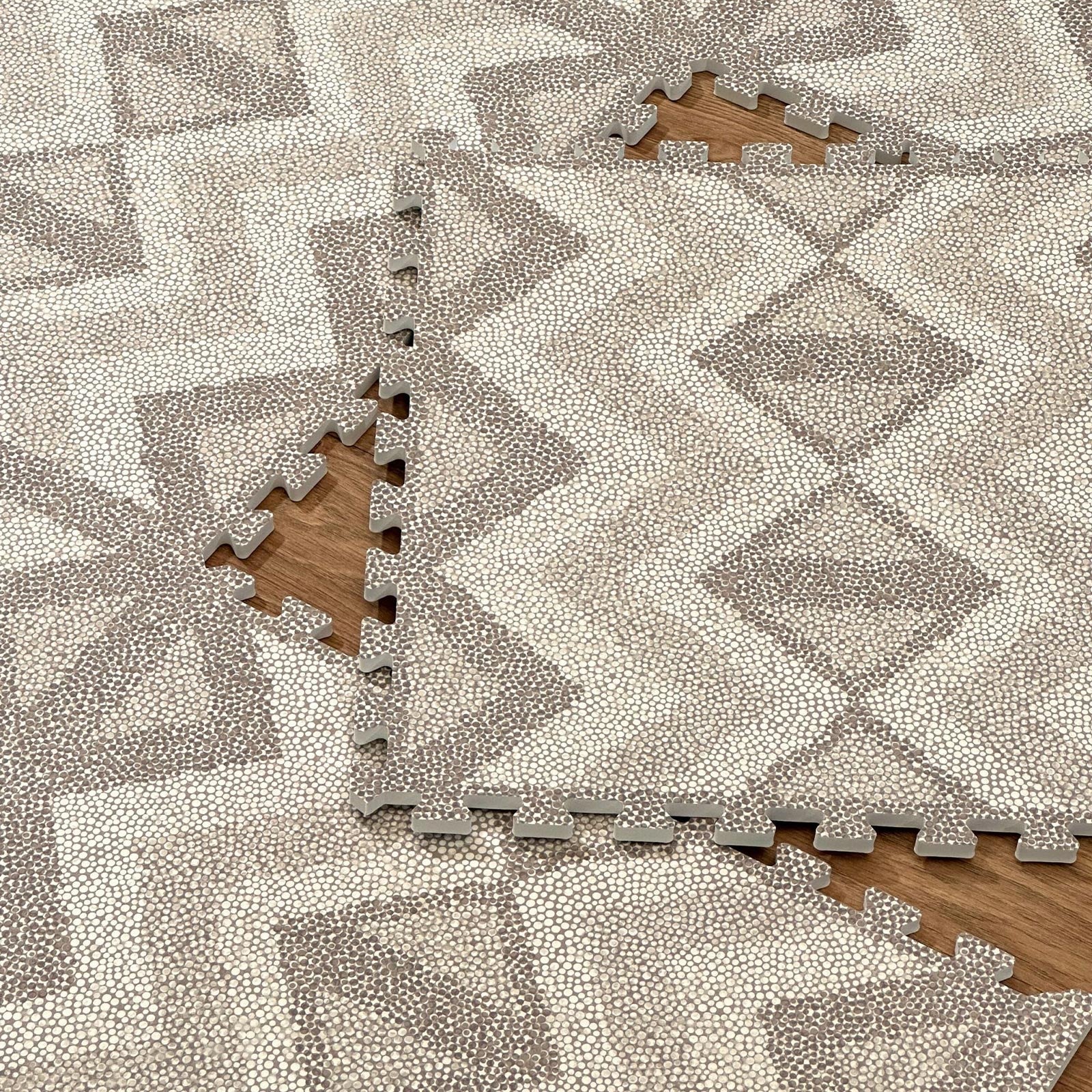 Close-up of an Eeveve Kilim Truffle play mat with tiles not yet clicked together, showing interlocking edges.