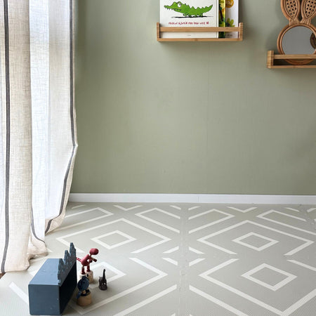 Play Mat Modern Blocks Soft Sage by Eeveve in a nursery with toys, offering a stylish EVA foam surface for babies and toddlers.