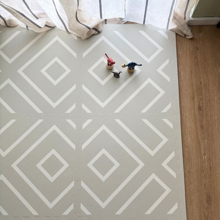 Top-down view of the Play Mat Modern Blocks Soft Sage with geometric patterns and toys, ideal for tummy time and toddler play in stylish interiors.
