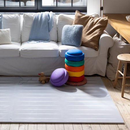 Lucio Nordic Mist play mat by Eeveve in a cozy living room, offering a safe, surface for babies and toddlers to play on.