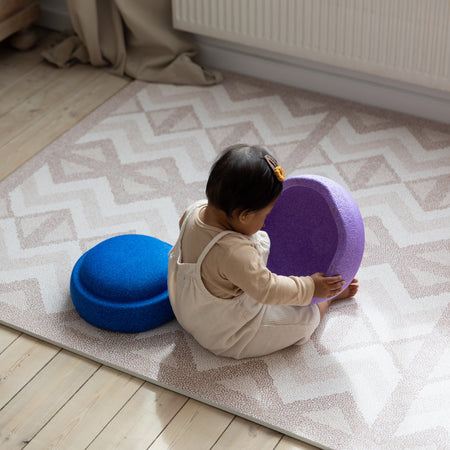 Baby playing on Eeveve Kilim Soft Clay EVA foam play mat with geometric pattern. And perfect for crawling and tummy time.