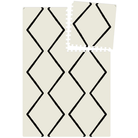 Top view of full Eeveve Beni - Ecru play mat layout with one tile detached, illustrating modular puzzle-piece design for flexible sizing.